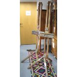 Two 20th century wooden artist’s studio easels, each 63” high.