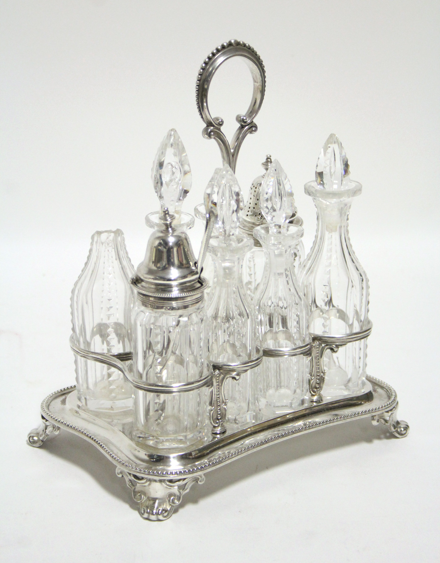 A Victorian rectangular eight-division cruet stand with centre ring handle, beaded rim, & on four