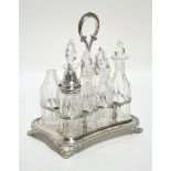 A Victorian rectangular eight-division cruet stand with centre ring handle, beaded rim, & on four