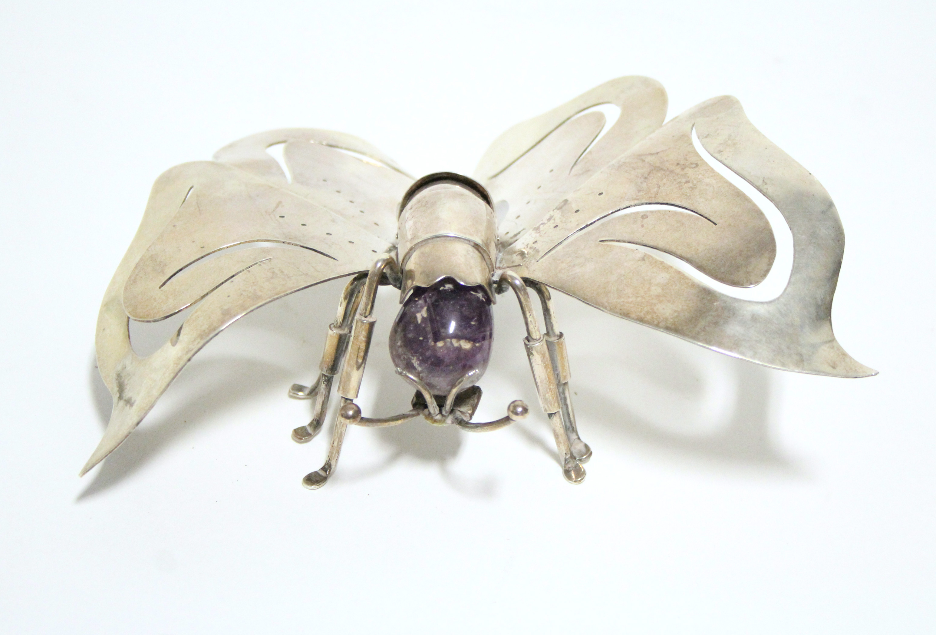 A continental .925 standard model of a butterfly with articulated abdomen & amethyst-quartz head;