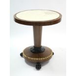 An early 19th century rosewood, ebonised & gilt centre table inset white marble to the circular top,
