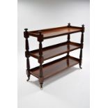 A Victorian mahogany three-tier dumb waiter on turned tapering reeded supports with carved terminals