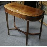A mid-late 19th century mahogany canteen table, the shaped rectangular fold-over top enclosing a