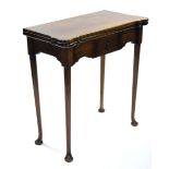 A late 18th century mahogany tea table with shaped fold-over rectangular top fitted frieze