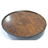 A mahogany “Lazy Susan” with pie-crust edge, on circular pedestal foot, 22” wide.