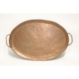 An Arts & Crafts oval copper two-handled copper tray by John Pearson, with maker’s stamps to the