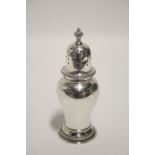 A plain baluster sugar castor with domed pierced cover, 6¼” high; London 1968, sponsor’s mark of Nat