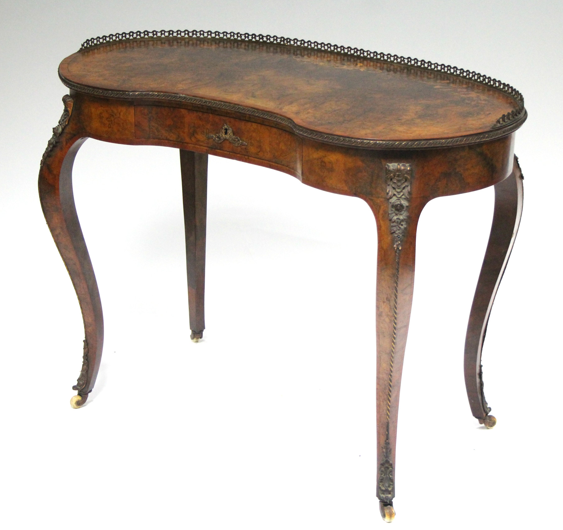 A mid-19th century burr-walnut kidney-shaped dressing table in the Louis XVI style, the