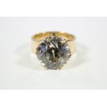 A WHITE TOPAZ RING, the large circular stone approx. 6 carats, set to a heavy yellow metal shank;
