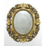 An 18th century Florentine carved giltwood frame oval wall mirror; 17½” x 15½”.