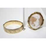 A late Victorian carved shell oval cameo brooch depicting Psyche & the Eagle of Zeus, in gilt-