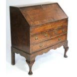 A Queen-Anne style burr-walnut veneered bureau, the sloping fall front enclosing a fitted