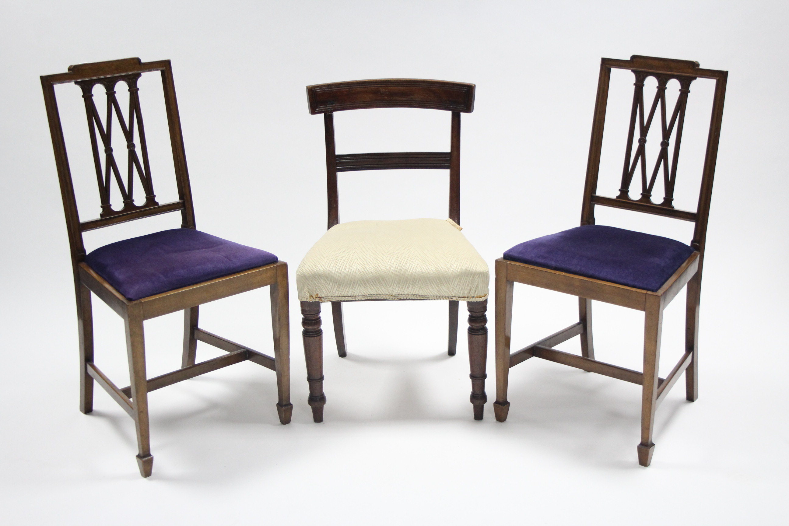 A pair of Sheraton-style mahogany occasional chairs with carved & pierced lattice backs, padded