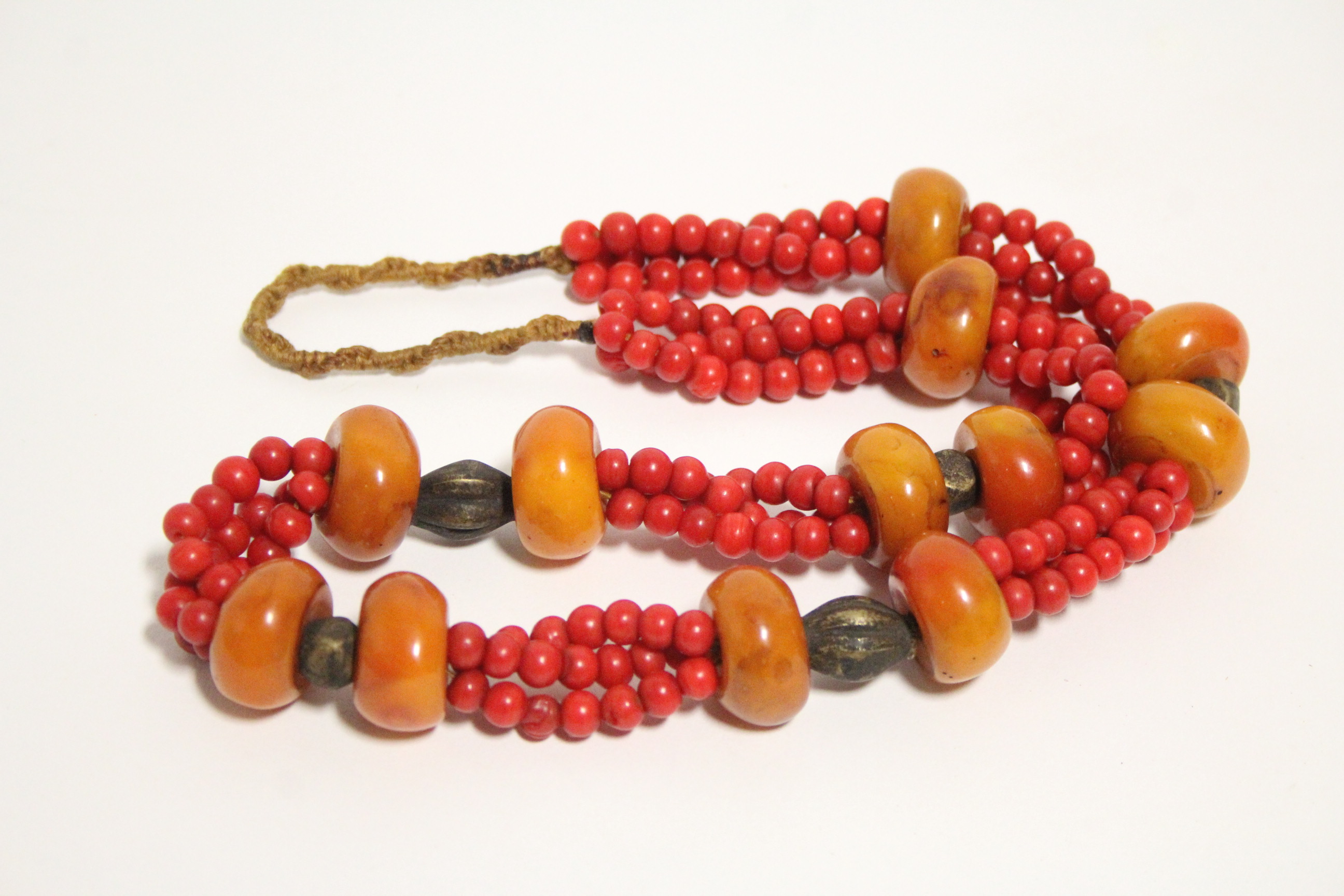 A necklace of irregular large squat round butterscotch amber beads between triple strands of - Image 2 of 2