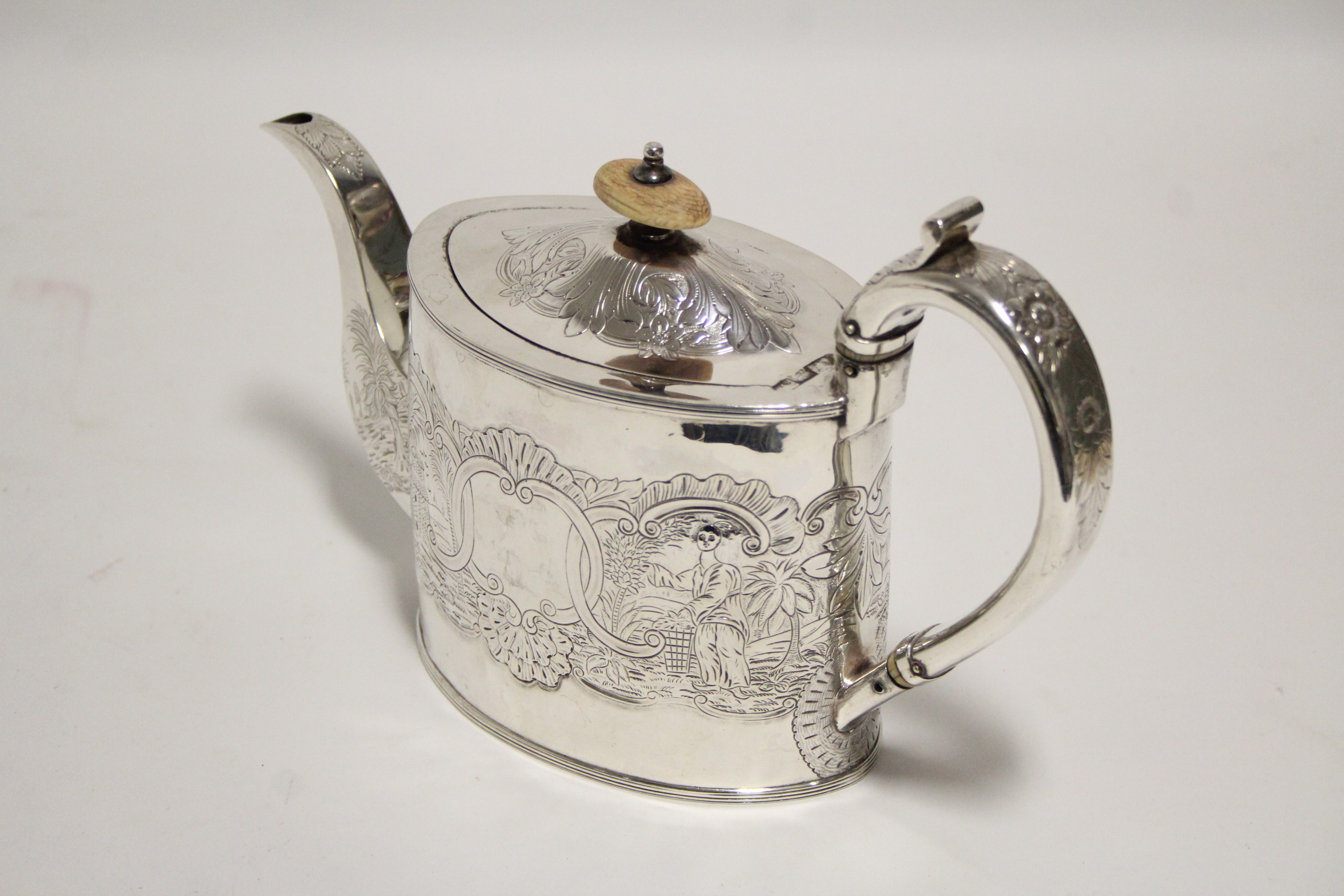 A George III oval straight-sided teapot with repoussé Chinoiserie decoration; London 1794, by - Image 2 of 3