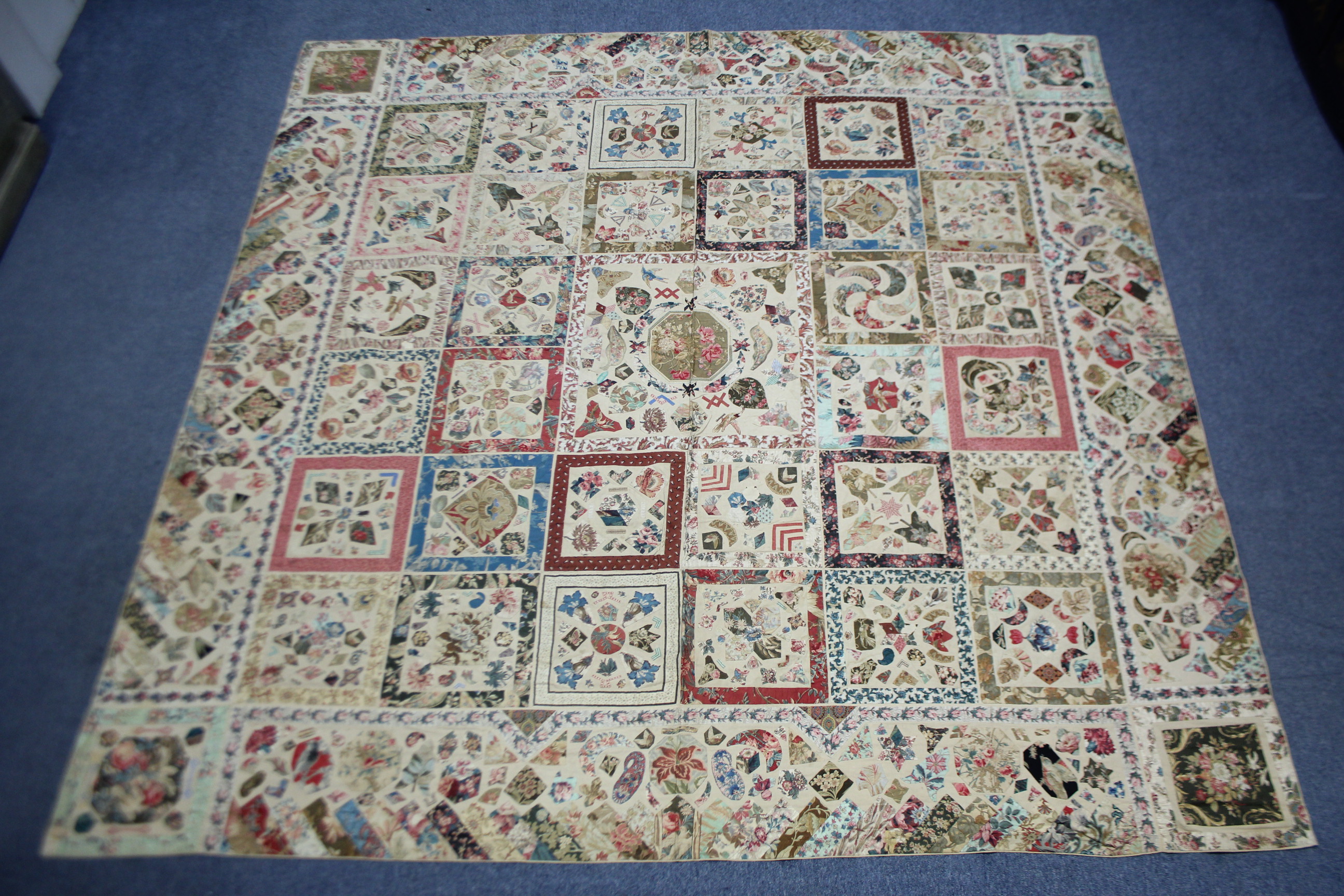 A VICTORIAN PATCHWORK BEDSPREAD or WALL HANGING comprising a wide variety of printed fabrics cut - Image 2 of 5