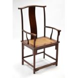 A Chinese hardwood armchair in the Ming style, with woven-cane square seat, 24” wide x 46” high.