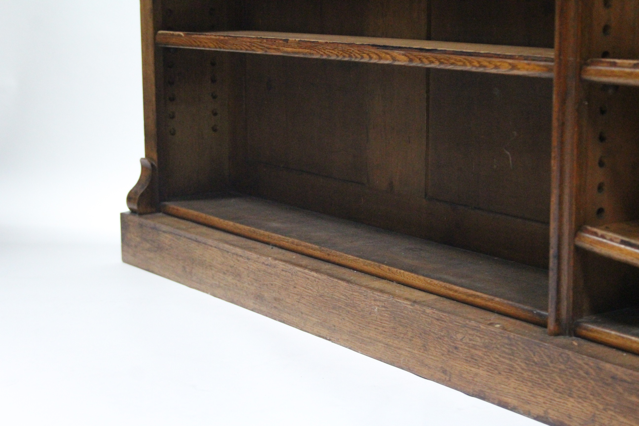 An early 19th century light oak standing open bookcase, having four adjustable shelves, plain scroll - Image 4 of 4