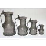 A matched set of four 19th century pewter graduated “Tappitt Hen” jugs, with double-acorn thumb-