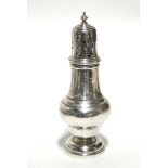 A baluster-shaped pepper pot, 5¼” high; London 1935, by S. Blanckensee & Sons.