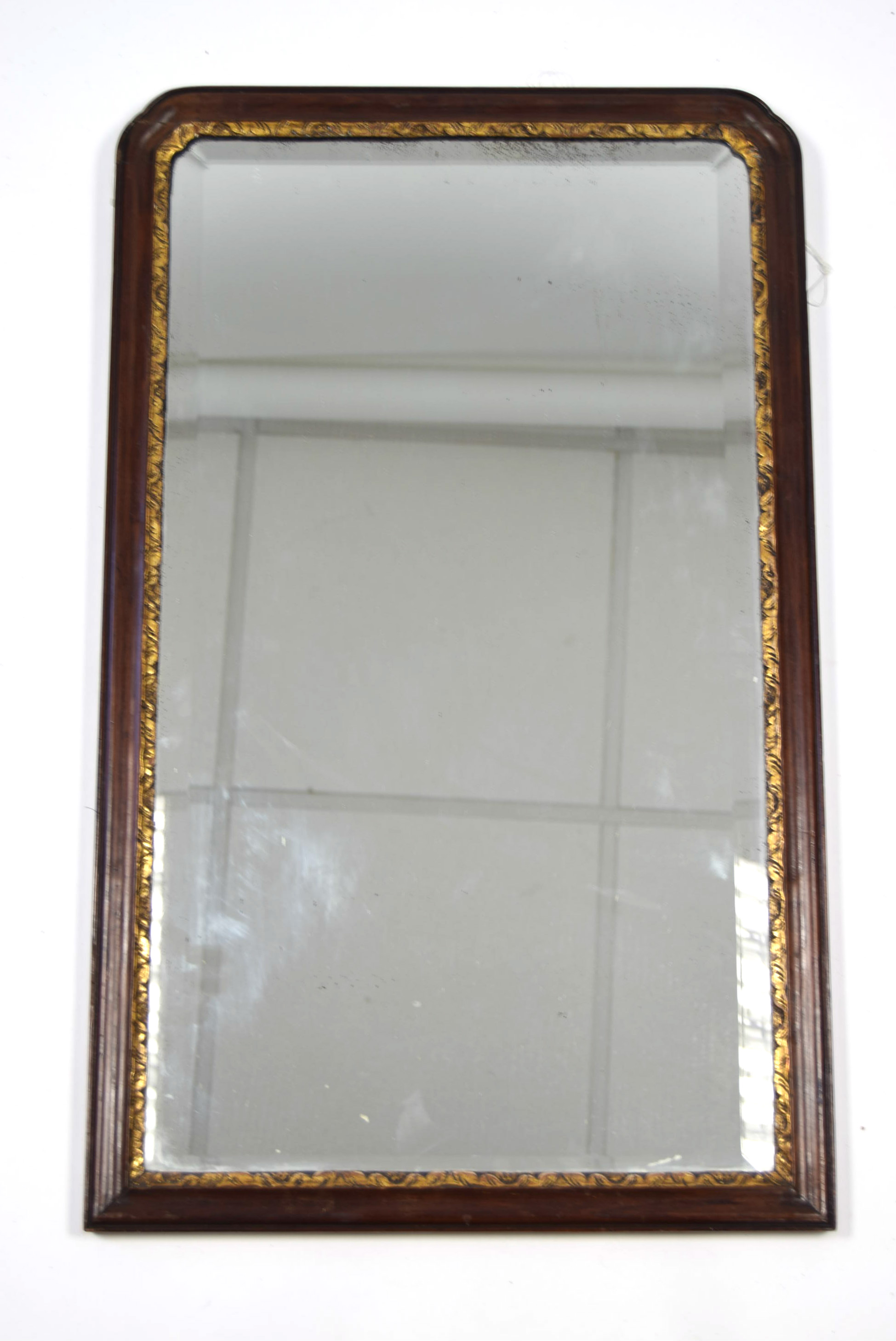 An early 19th century mahogany & parcel-gilt frame rectangular bevelled wall mirror; 30¾” x 18¾”.