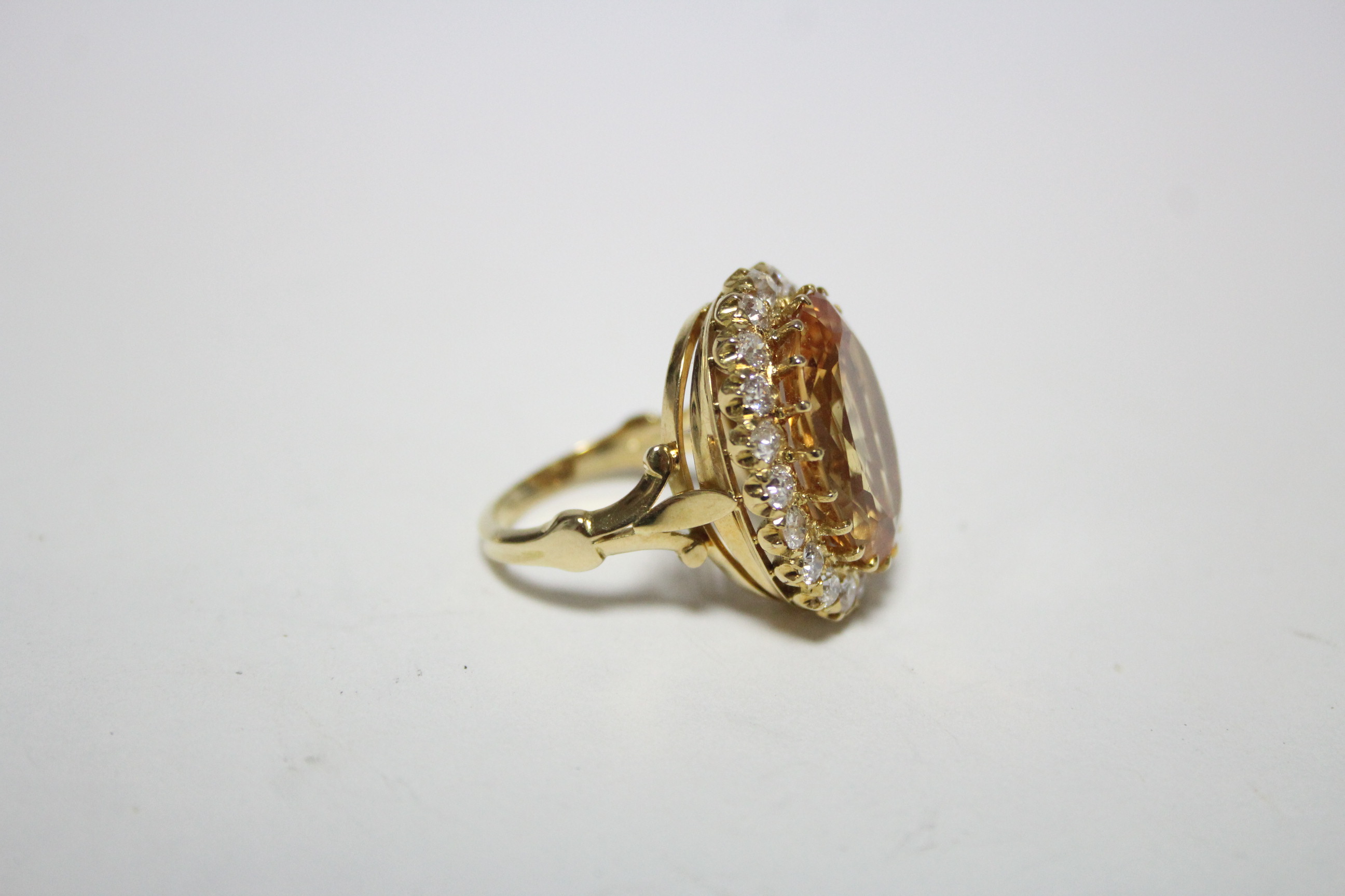 AN 18ct. GOLD, TOPAZ, & DIAMOND RING, the large oval topaz measuring approx. 19mm x 15mm, set within - Image 2 of 3