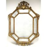 A 19th century CONTINENTAL CARVED GILTWOOD FRAME RECTANGULAR WALL MIRROR, with canted corners with