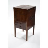 An early 19th century mahogany envelope top commode fitted central cupboard & two drawers below,