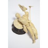 A Japanese carved ivory sectional okimono of a farmer standing with a spade in his right hand, a
