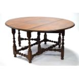 A good early 19th century mahogany large oval gate-leg dining table, on baluster-turned supports &