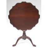 A George III mahogany tripod table with pie-crust edge, on central gun-barrel column & cabriole