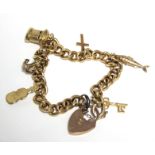 A 9ct. gold curb-link bracelet with six hallmarked pendant charms, & with padlock clasp & safety