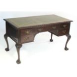 A good quality mahogany kneehole writing desk in the Chippendale style, the rectangular top with