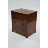 A Georgian-style small mahogany chest, fitted four long gradated drawers, on splay feet, 22½” wide.