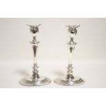 A pair of late 18th century style candlesticks with oval tapered columns, removable drip-pans to the