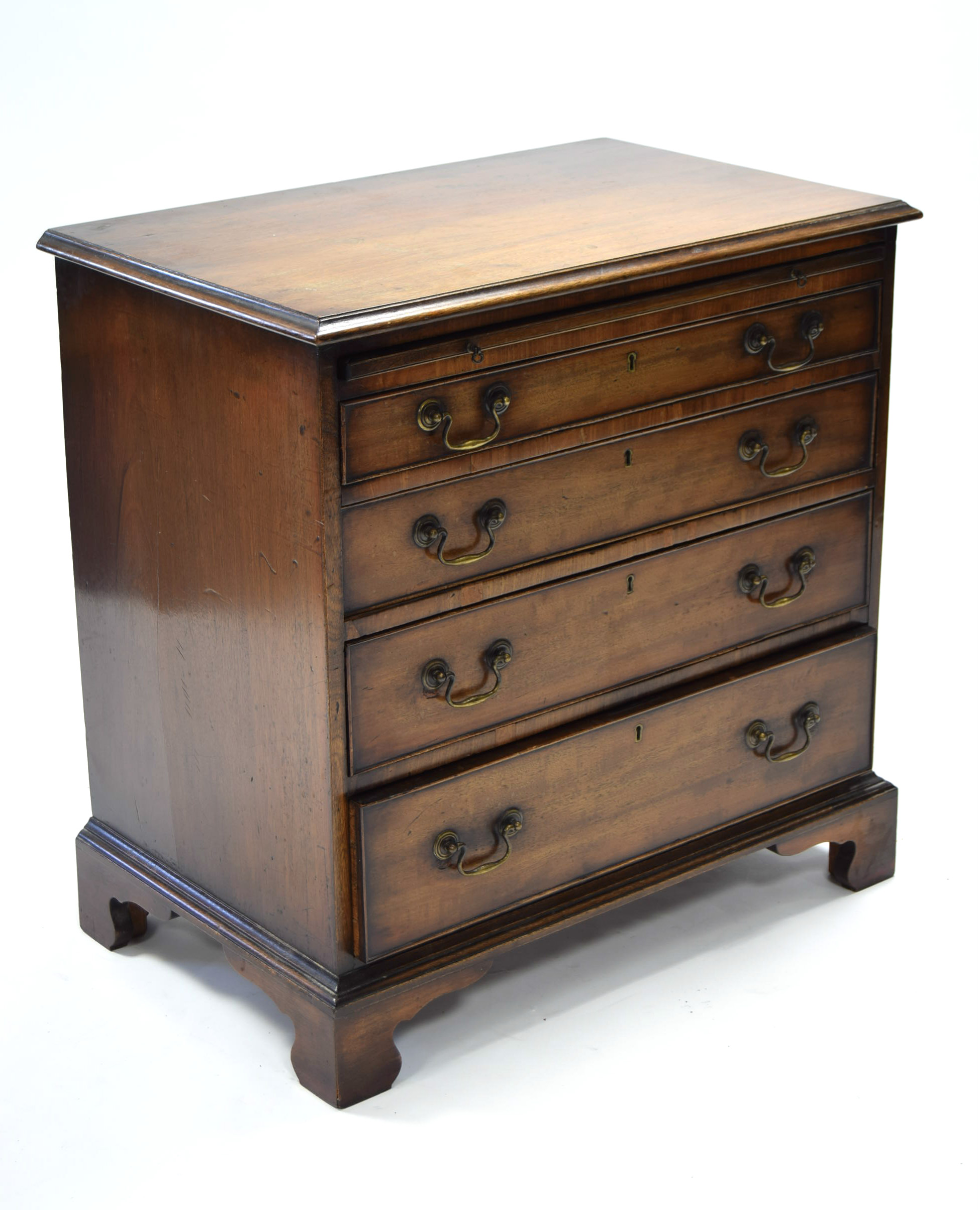 An early Victorian mahogany chest of four long graduated drawers with original brass swan-neck