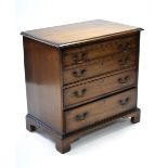 An early Victorian mahogany chest of four long graduated drawers with original brass swan-neck