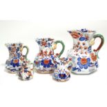 A matched graduated set of five early Mason's Ironstone octagonal baluster "Hydra" jugs with