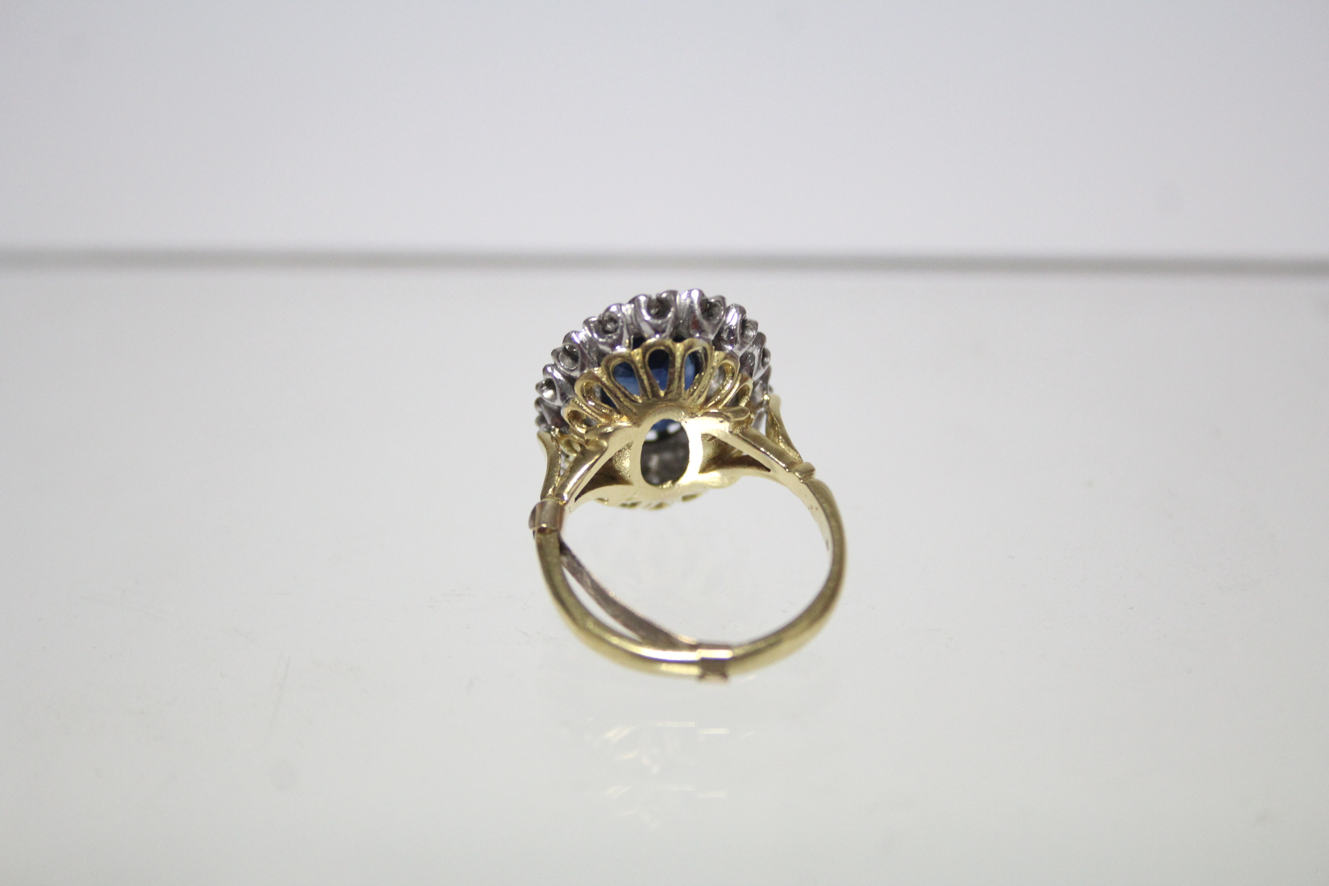 An 18ct. gold ring set oval sapphire within a border of small diamonds; London hallmarks for - Image 3 of 3