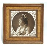 A Minton pottery large square tile with sepia photographic head-&-shoulders portrait of a young