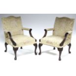 A PAIR OF GEORGE III STYLE MAHOGANY OPEN ARMCHAIRS with carved mahogany frames, upholstered brass-