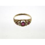 An 18ct. gold ring set three graduated rubies separated by two small diamonds; Birmingham