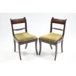 A pair of regency mahogany bow-back dining chairs with rope-twist centre rails, padded drop-in seats