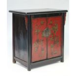 An antique Chinese lacquer cabinet enclosed by a pair of panel doors decorated all-over with