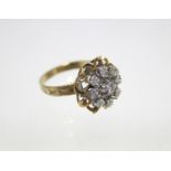 An 18ct. gold ring set cluster of small diamonds. (size K/L).