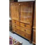 An early Victorian mahogany linen press, fitted three sliding trays enclosed by pair of fielded