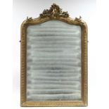 A 19th century RECTANGULAR WALL MIRROR, in carved giltwood frame with floral scroll surmount