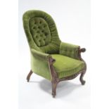 A mid-Victorian carved mahogany frame armchair upholstered green velour to the buttoned & pleated