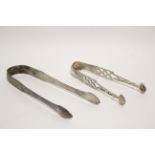 A pair of Victorian sugar tongs in the mid-18th century style, with pierced stems & shell bowls,