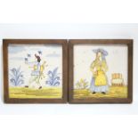 A pair of Spanish polychrome faience pottery large square tiles painted with full-length male &